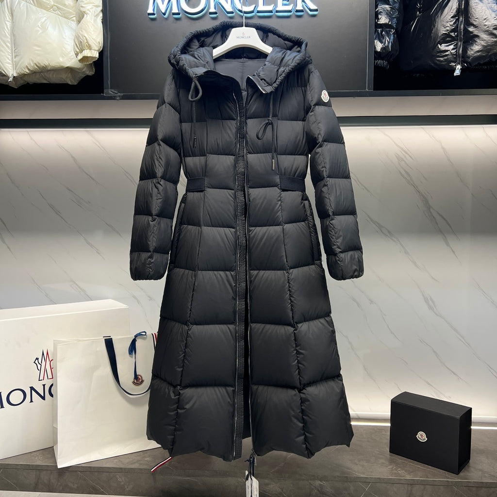 Long puffer coat with drawstring hood, quilted blocks, and front zipper