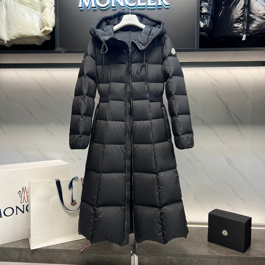 Long puffer coat with drawstring hood, quilted blocks, and front zipper