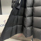 Long puffer coat close-up of quilted shoulder and sleeve with zipper