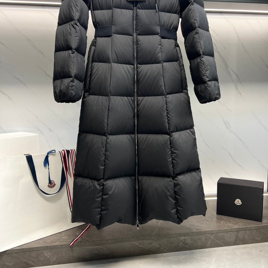 Long puffer coat in side view with quilted panels and center front zipper