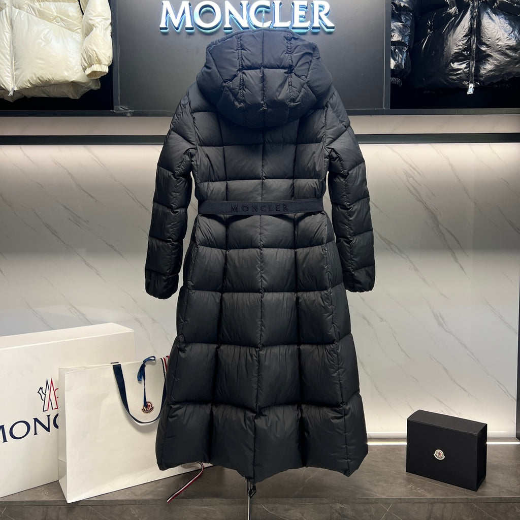 Long puffer coat back view with hood, quilted panels, and center zipper