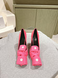 Pink Balenciaga sandals with black lining, knotted front detail and stiletto heel