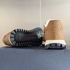 Tan sneaker outsole view with black tread and heel, white midsole
