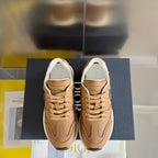 Tan lace-up sneakers with white interior lining and C logo detail on the side