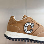 Tan sneaker side view with C logo emblem, white midsole and lace-up closure