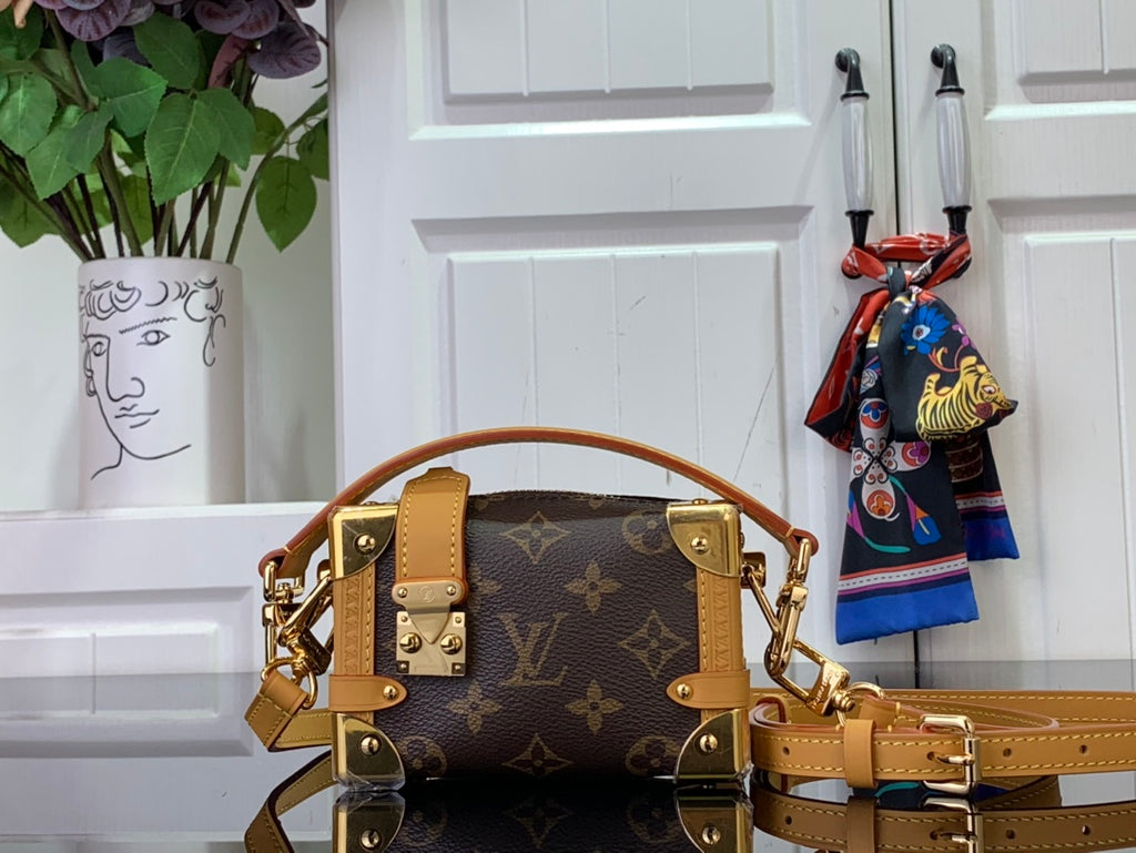 Louis Vuitton bag in dark brown monogram canvas with tan leather handles and gold hardware