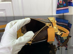 Louis Vuitton bag open top showing dark interior and gold zipper with tan trim