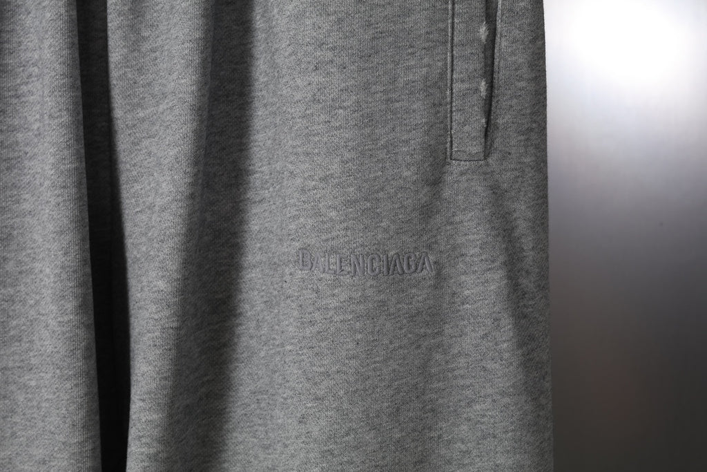 Heather gray pants with welt pocket and subtle logo embroidery