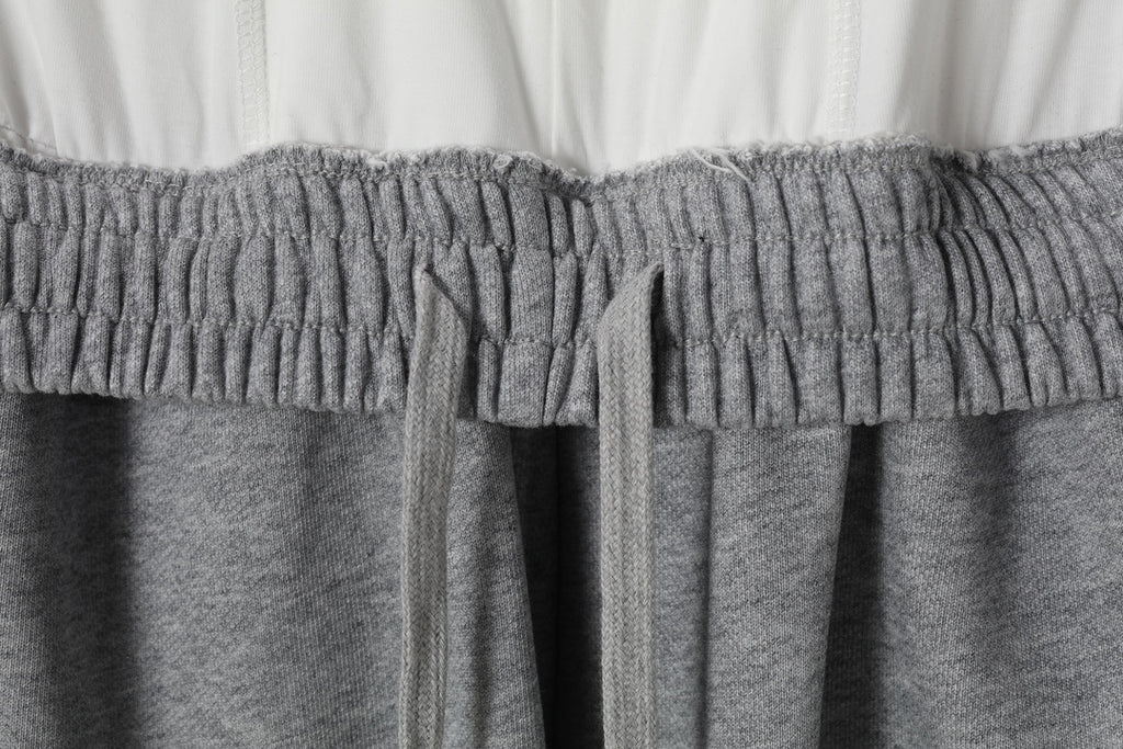 Grey sweatpants waistband with elastic smocking and inner drawstring ties