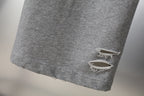 Grey sweatpants hem with frayed distressed knee rip detail