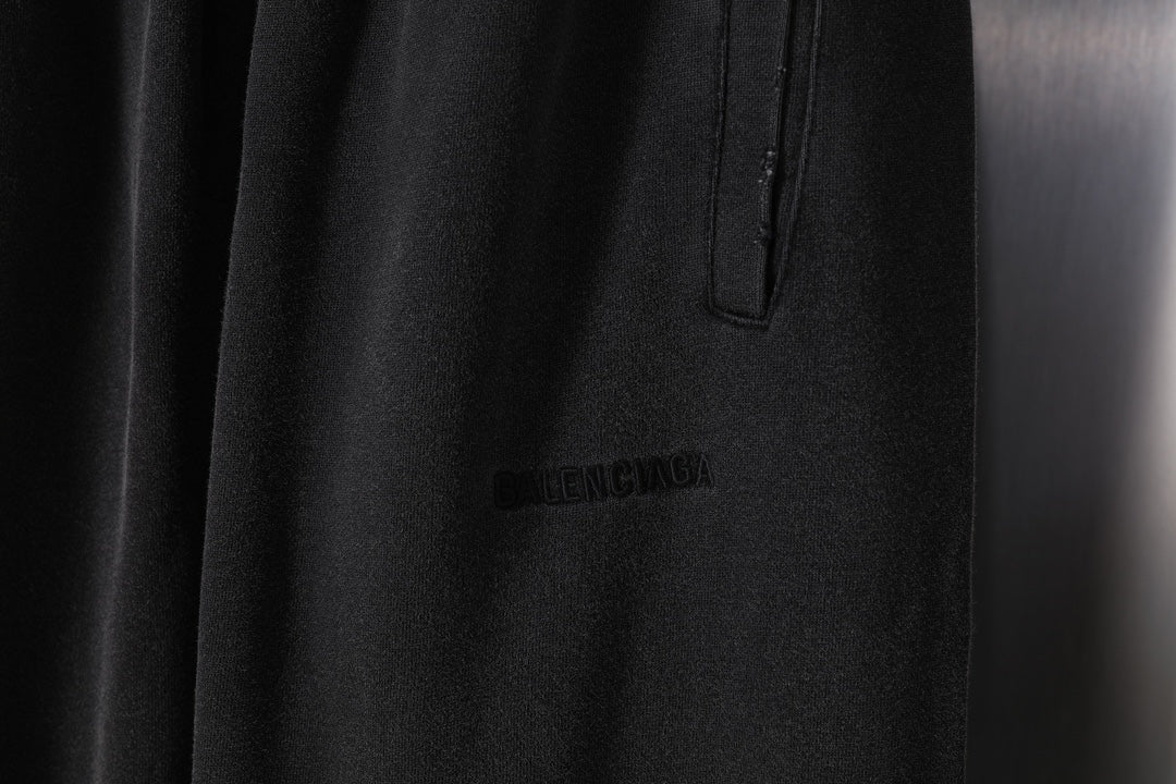 Black pants with front button placket detail and small logo print