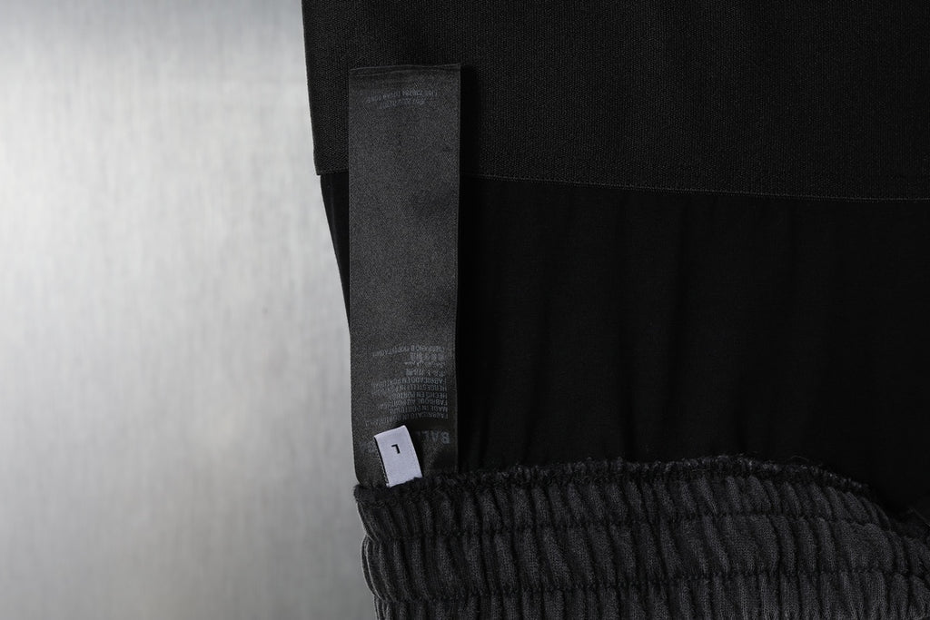 Black sweatpants with side seam panel and interior care label tag