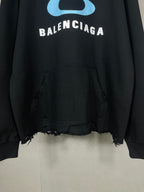Balenciaga long black hoodie with blue eye logo, BALENCIAGA text, and kangaroo pocket