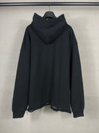 Black long hoodie back view with oversized hood and frayed lower hem