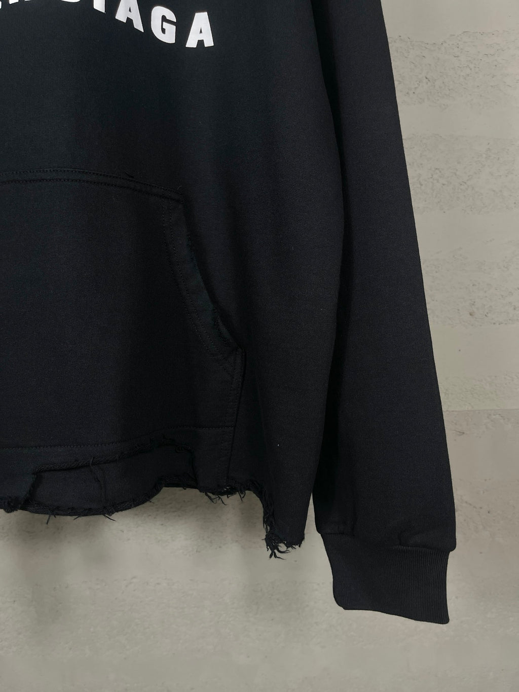 Balenciaga long black hoodie sleeve cuff and frayed hem at bottom