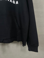 Black hoodie sleeve and hem with frayed edge and kangaroo pocket