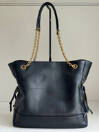 YSL tote bag in dark navy leather with gold chain handles and side ribbon ties