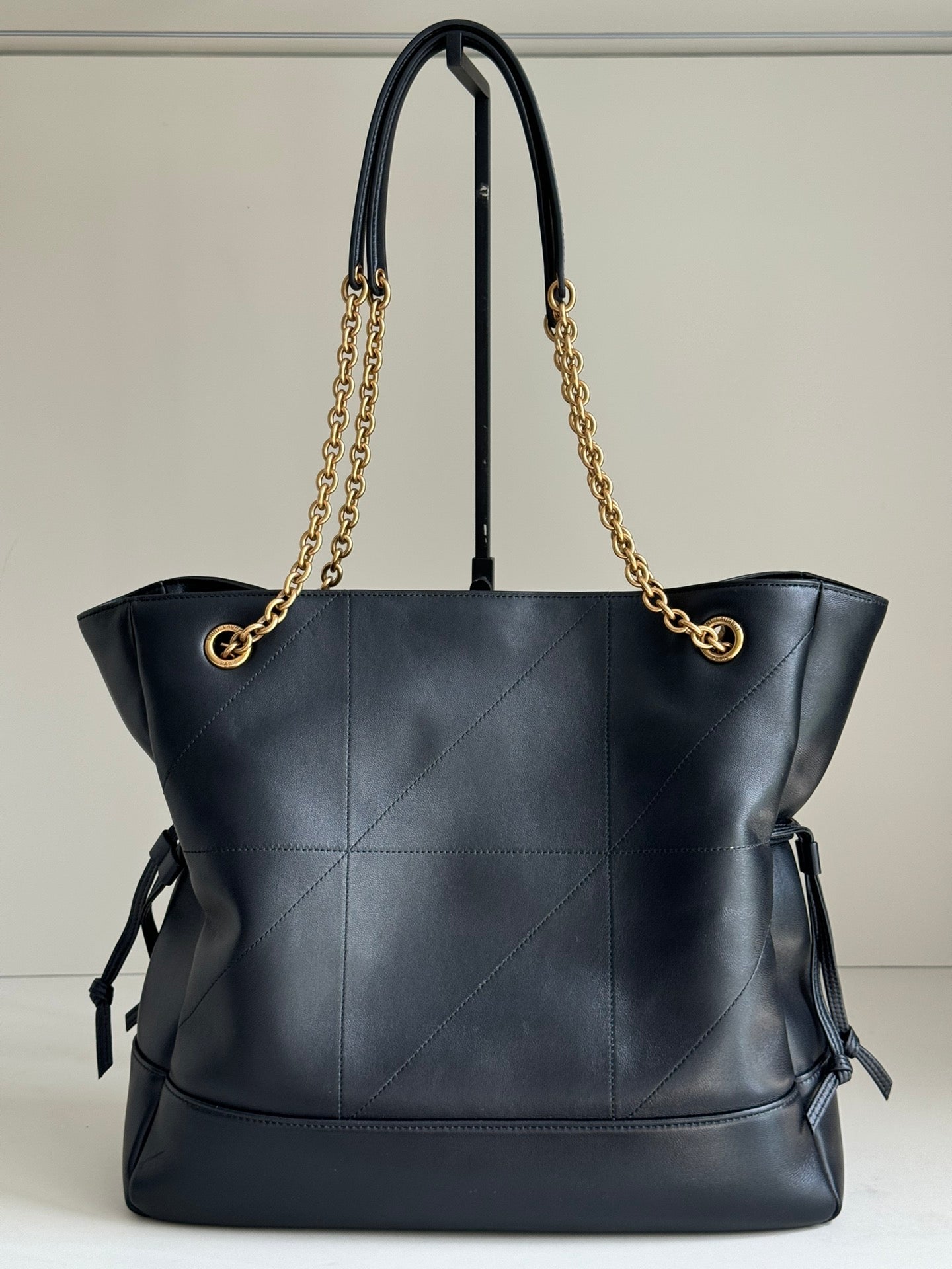 YSL tote bag in dark navy leather with gold chain handles and side ribbon ties