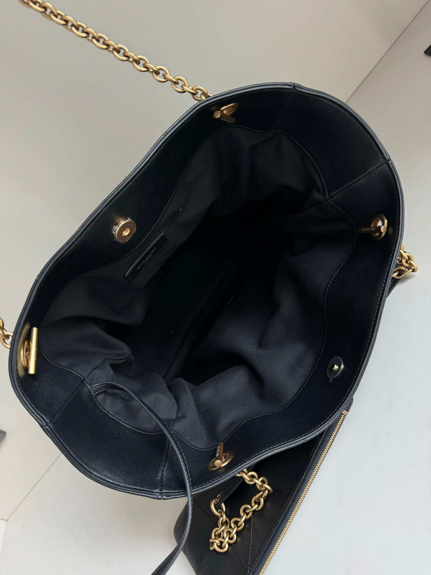 YSL tote bag interior in dark leather with pouch pocket and gold zipper hardware