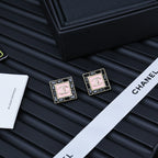 Pair of square Chanel logo stud earrings with pink enamel panels and gold-tone trim