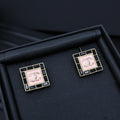 Square Chanel logo stud earrings with pink enamel and gold-tone border, set of 2