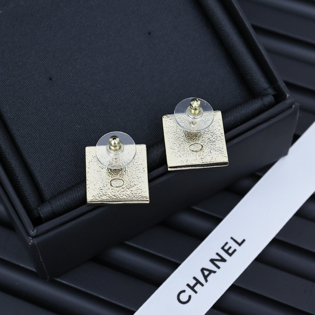 Square Chanel logo stud earrings with gold-tone backs and circular posts