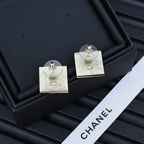 Square Chanel logo stud earrings with gold-tone backs and circular posts