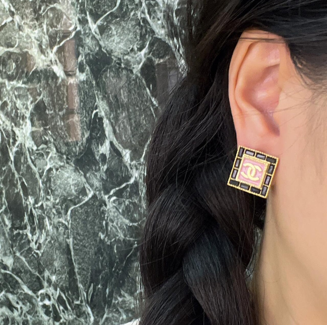 Square Chanel logo stud earring with pink enamel center on ear