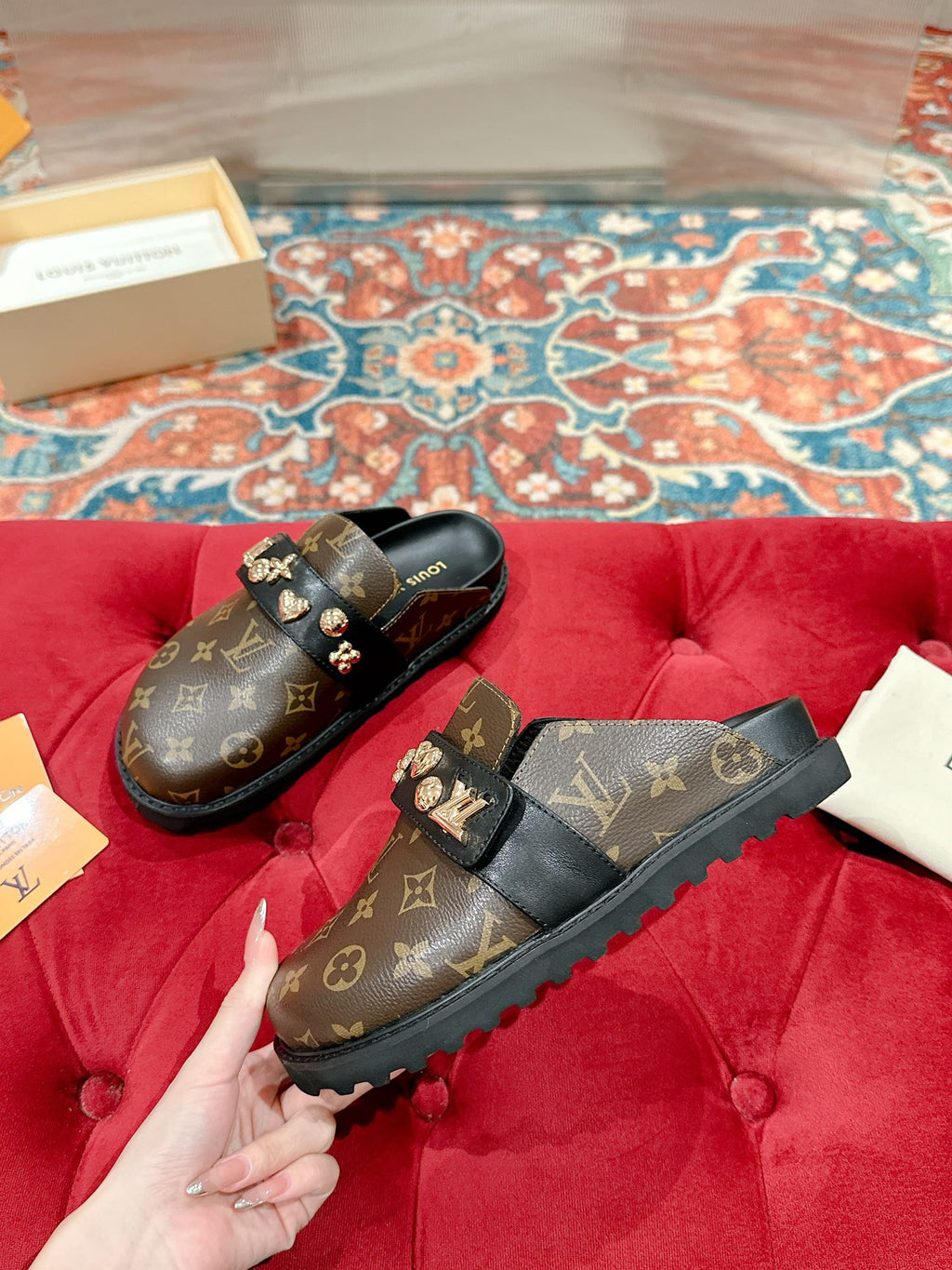 Louis Vuitton monogram slide sandals, black with gold-tone emblem buckles and strap.
