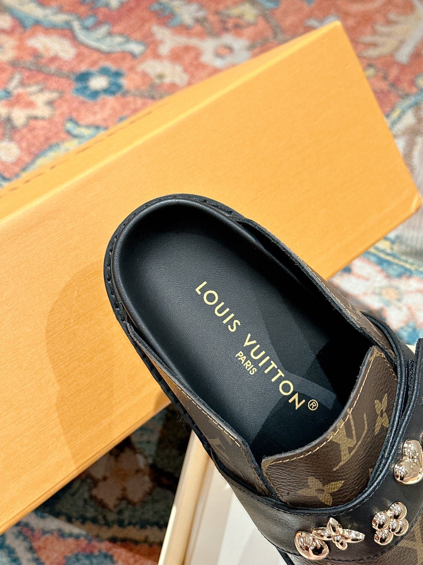 Louis Vuitton monogram slide sandal with black leather lining and gold-tone hardware.