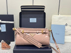 Pink leather handbag with front strap detail and gold-tone hardware, shoulder carry