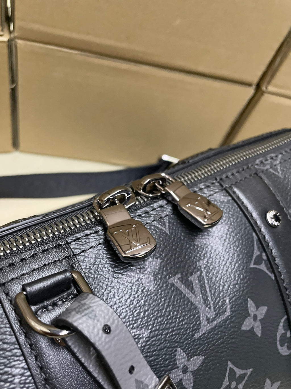 Monogram canvas bag close-up: zipper and metal hardware
