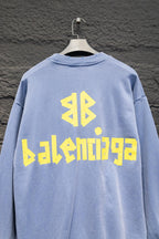Light blue sweatshirt back view, crewneck, long sleeves, Balenciaga logo graphic.