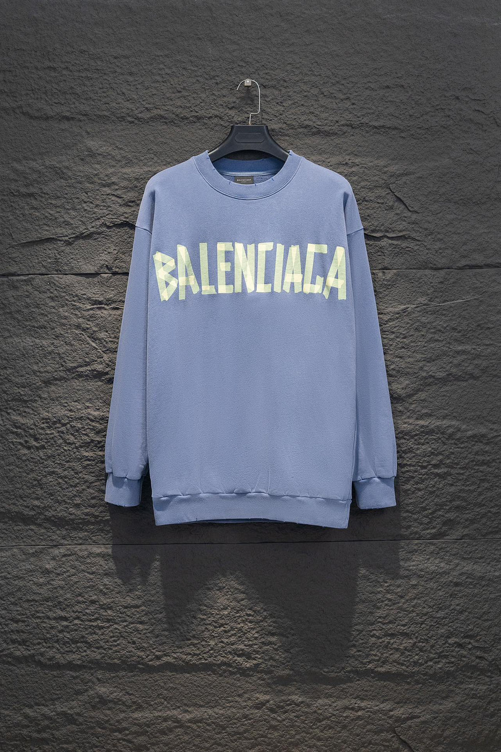 Light blue sweatshirt, crewneck, long sleeves, ribbed cuffs, Balenciaga logo front.