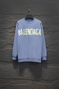 Light blue sweatshirt, crewneck, long sleeves, ribbed cuffs, Balenciaga logo front.