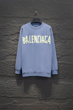 Light blue sweatshirt, crewneck, long sleeves, ribbed cuffs, Balenciaga logo front.