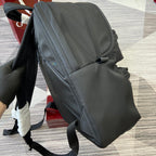 Gucci men’s backpack side view with curved pocket seams and black shoulder strap