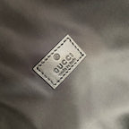 Gucci logo label patch on gray backpack interior with white printed text