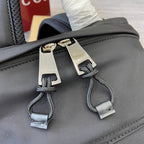 Gucci men’s backpack zipper pulls with metal logo tabs and corded accents