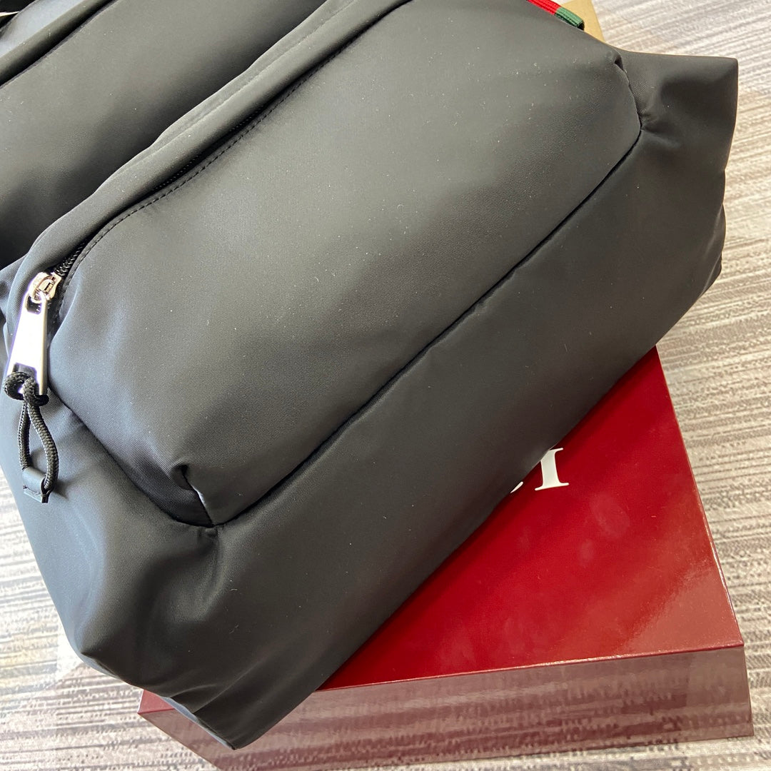 Gucci men’s backpack side close-up with zip pocket and smooth dark gray panel