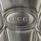 Gucci logo oval on black leather backpack front with stitched edging