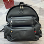 Gucci black backpack with front zip pockets and leather straps