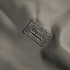 Gucci woven fabric label on black backpack interior