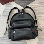 Gucci black backpack with front flap, two zip pockets, and shoulder straps