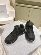 Dior unisex black sneakers on a display, lace-up with textured toe cap