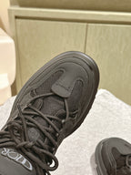 Dior unisex sneaker close-up, black upper with lace eyelets and mesh texture