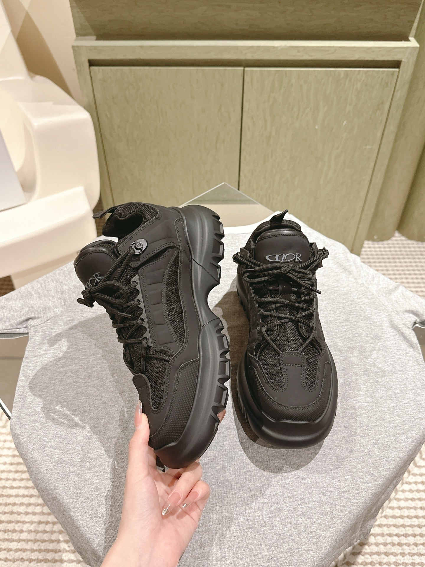 Dior unisex sneakers, black with mesh panels and lace-up closure, side view