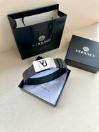 Leather belt with dark strap and white buckle plate with VJ logo