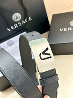 Close-up of dark blue leather belt with silver VJ logo buckle