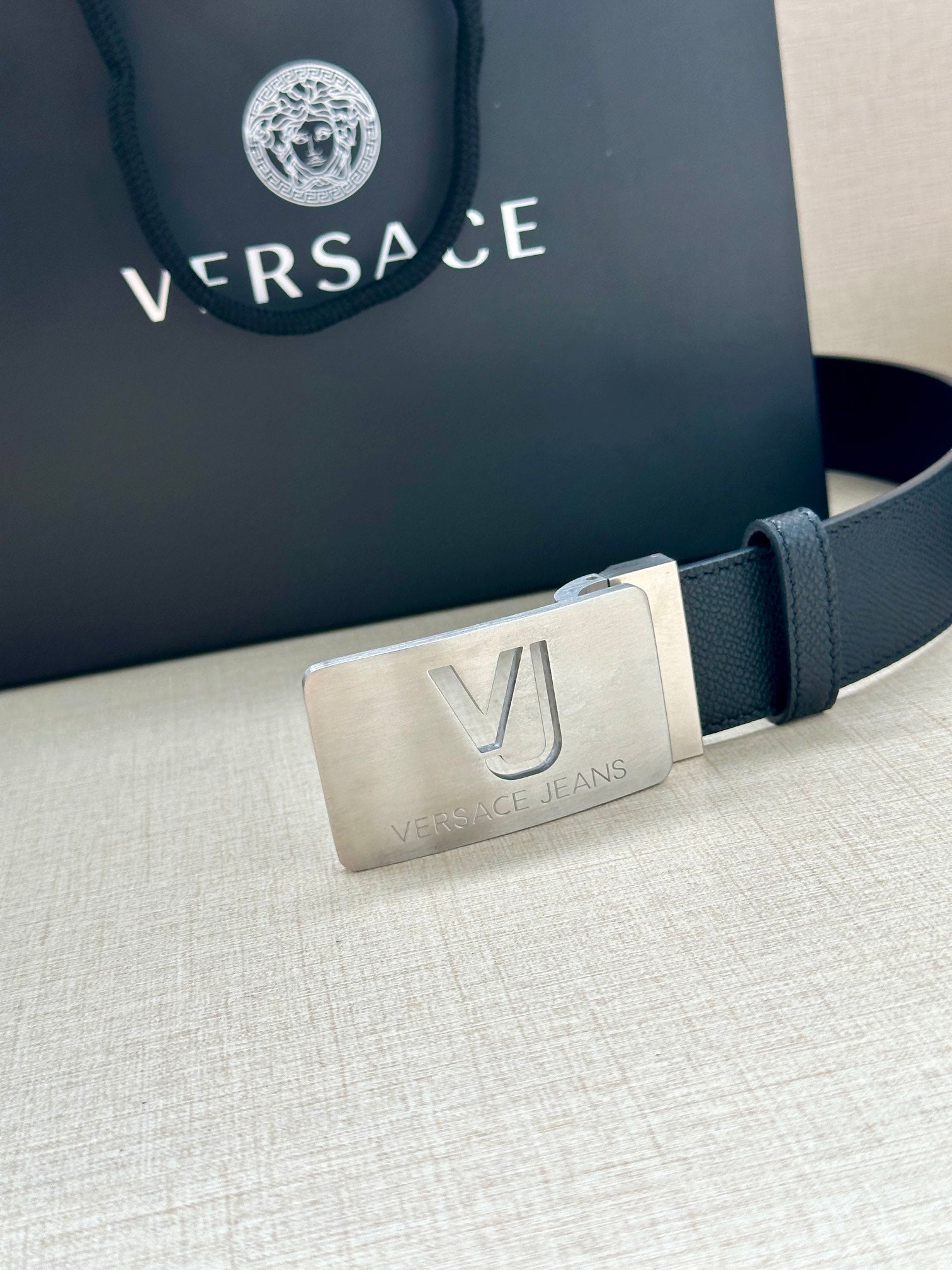 Dark blue Versace belt with silver square buckle and VJ logo